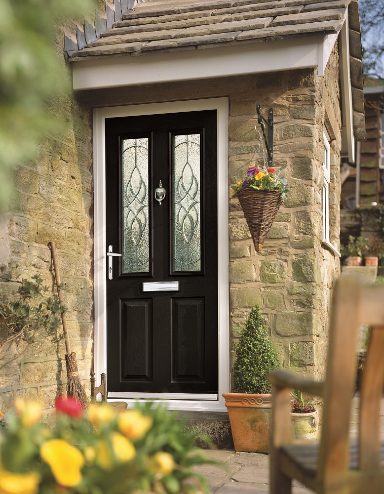 a black door with yellow flowers outside it